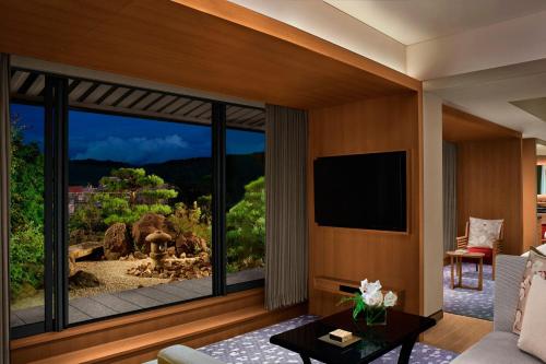 a living room with a large window with a view at The Ritz-Carlton Kyoto in Kyoto