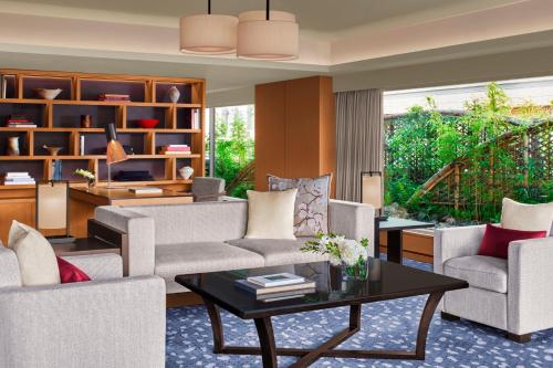 a living room with a couch and chairs and a table at The Ritz-Carlton Kyoto in Kyoto