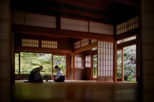 a couple of people sitting in a building at The Ritz-Carlton Kyoto in Kyoto