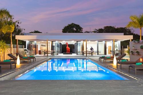 a swimming pool at night with a building at Brand-new 8BR Private Pool Villa Mystic Garden in Rawai Beach