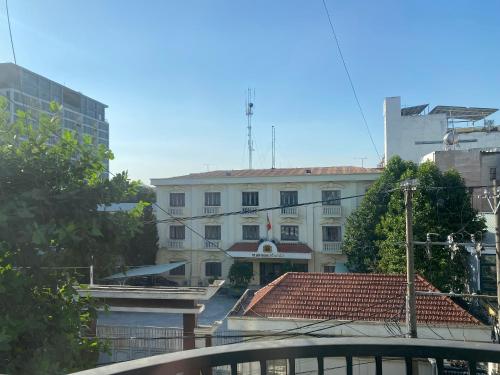 a white building with a red roof in a city at Start House CAPSULE 5 min walk to the Airport in Ho Chi Minh City