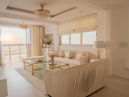 a living room with a couch and a table at Beachfront Seaview Apartment in Male City