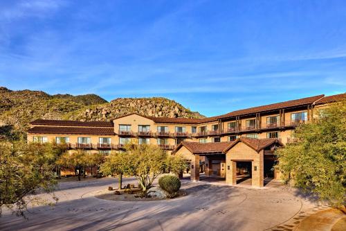 an exterior view of a hotel with mountains in the background at The Ritz-Carlton, Dove Mountain in Marana
