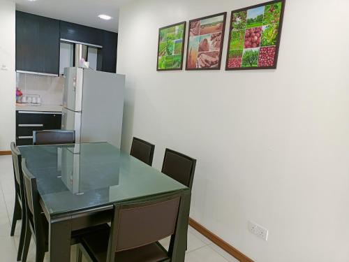a kitchen with a table with chairs and a refrigerator at Sekinchan HighLevel SeaView Homestay 高楼 看海 阳台民宿 in Sekincan