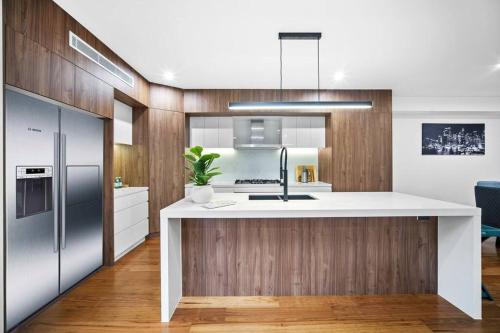 a kitchen with a white counter top and a refrigerator at Luxury Retreat & Spacious 4BR House in Willoughby in Sydney