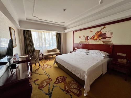 a hotel room with a bed and a television at Foshan Shiwan Hotel in Foshan