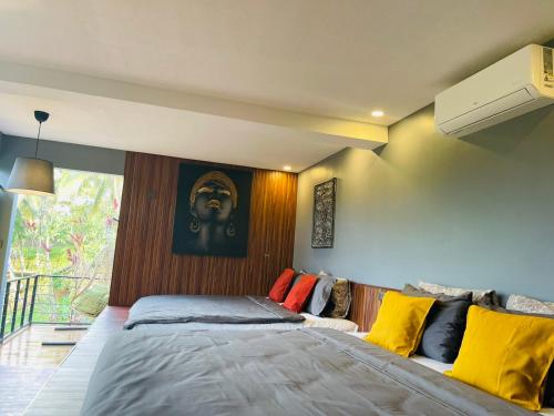 a bedroom with a large bed with colorful pillows at Jinjer Resort in Cavinti