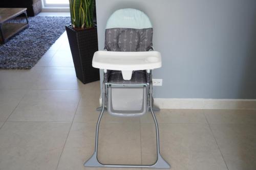 a white high chair sitting on a tile floor at Cielomar in Tijuana