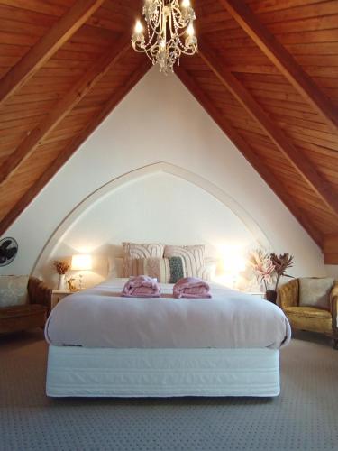 a bedroom with a bed in an attic at Kingsdown Manor B&B Timaru in Timaru