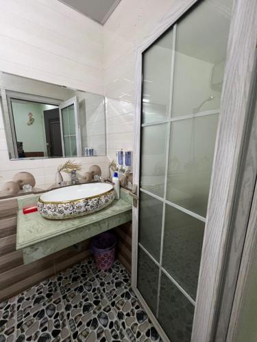 a bathroom with a sink and a shower at Ruby Hostel Hà Giang in Ha Giang