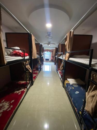 a hallway with several bunk beds in a room at Ruby Hostel Hà Giang in Ha Giang