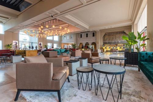 een lobby met banken en tafels en een restaurant bij Eden Andalou Aquapark & Spa in Marrakesh