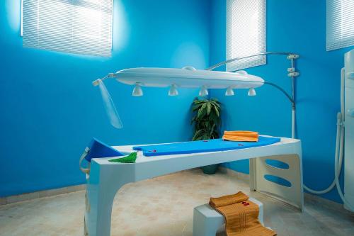 a blue room with a table with a sink at Eden Andalou Aquapark & Spa in Marrakech