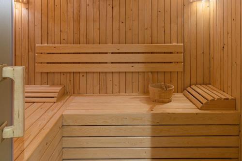a sauna with a bench and a bucket in it at Eden Andalou Aquapark & Spa in Marrakech