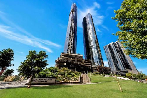 two tall skyscrapers in a city with a park at Melbourne Square Apartments in Melbourne