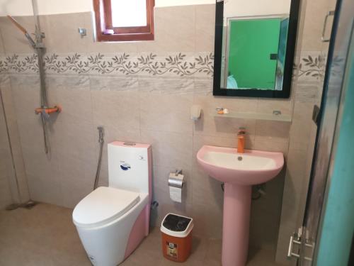 a small bathroom with a toilet and a sink at Rohana Holiday Resort yala in Tissamaharama