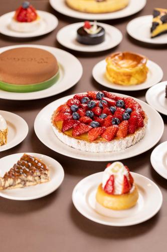 a table with plates of pastries and desserts on them at Pudong Shangri-La Shanghai - With a sweeping view of the Pearl Tower and the historic Bund skyline in Shanghai