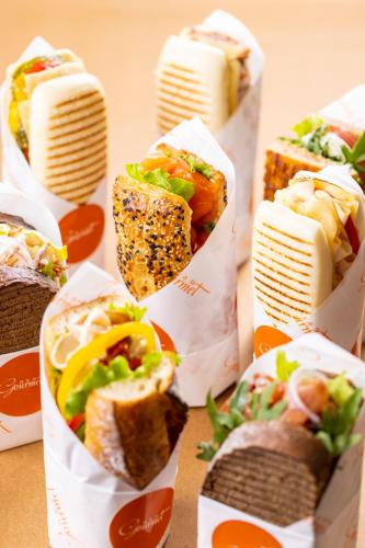 a group of sandwiches in paper bags on a table at Pudong Shangri-La Shanghai - With a sweeping view of the Pearl Tower and the historic Bund skyline in Shanghai
