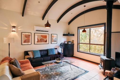 a living room with a couch and a table at Heavenly Retreat in Halls Gap