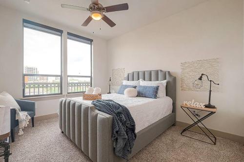 a bedroom with a bed and a ceiling fan at Elite Retro Urban Luxe in Houston