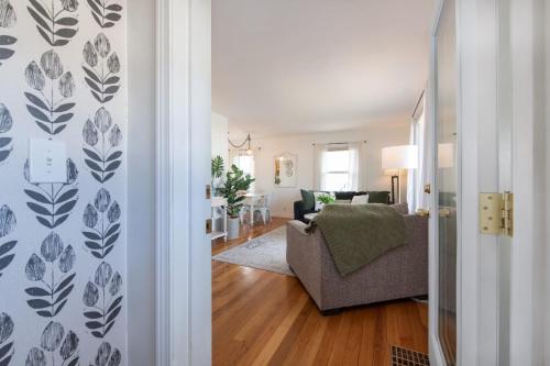 a living room with a chair and a couch at Sunlit Scandi Haven - Walk to Whitworth U & Shops in Nine Mile Falls