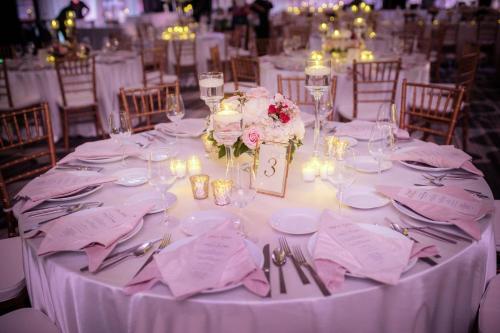 a table with a white table cloth and flowers on it at Omaha Marriott Downtown at the Capitol District in Omaha