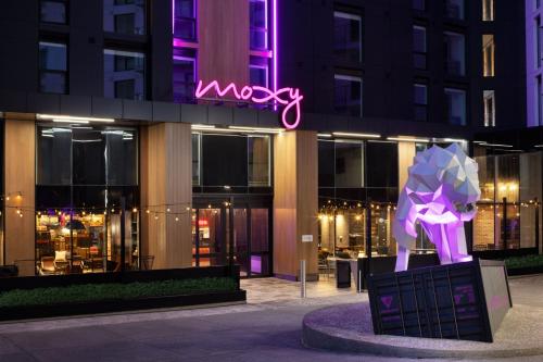 a building with a neon sign in front of it at Moxy Halifax Downtown in Halifax