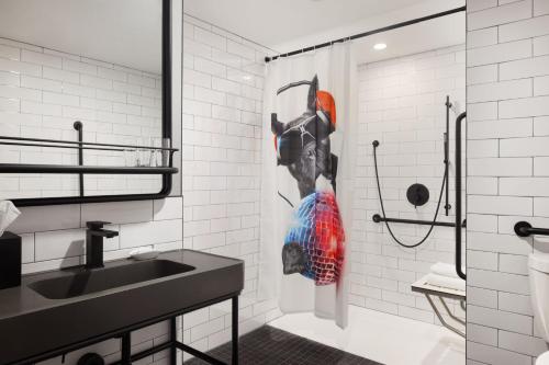 a bathroom with a shower and a sink at Moxy Halifax Downtown in Halifax