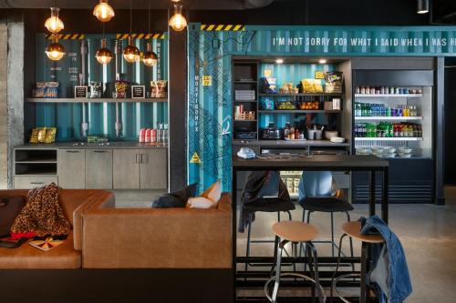 a bar with a couch and a table in a room at Moxy Halifax Downtown in Halifax