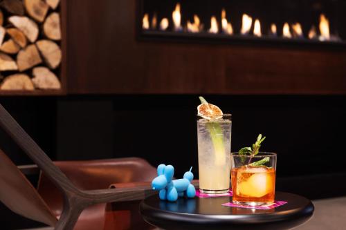 two cocktails sitting on a table in a restaurant at Moxy Halifax Downtown in Halifax