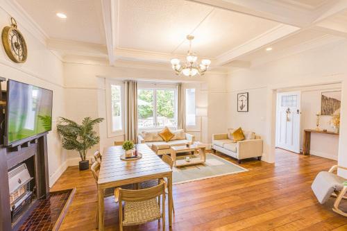 a living room with a table and a tv at Feels like your home ! in Auckland