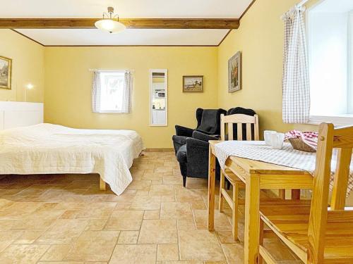 een slaapkamer met een bed, een bank en een tafel bij 3 person holiday home in SKIVARP in Skivarp