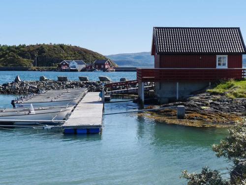 a group of boats docked at a dock in the water at 6 person holiday home in Brekstad in Brekstad