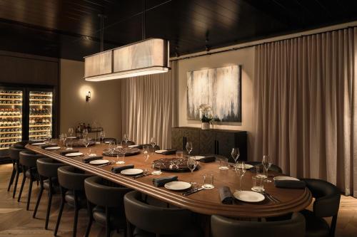 a long dining room with a long table and chairs at Sheraton Grand Sydney Hyde Park in Sydney