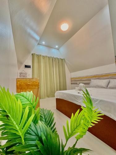a bedroom with two beds and green plants at Villa Lovi Panagsama Beach Moalboal in Moalboal