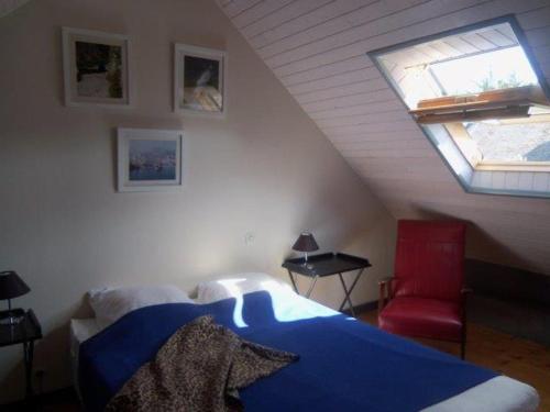 a bedroom with a bed and a window in a attic at Maison Locmaria, 2 pièces, 2 personnes - FR-1-418-252 in Locmaria