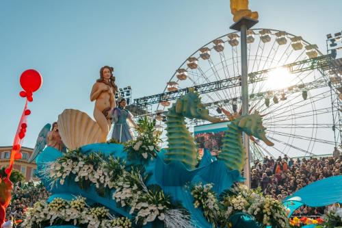 a carnival with a ferris wheel in the background at Le Meridien Nice in Nice