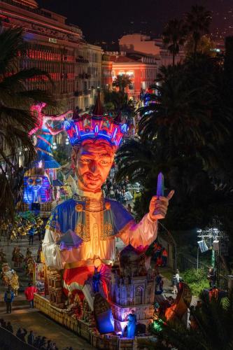 a large statue of a man is lit up at night at Le Meridien Nice in Nice