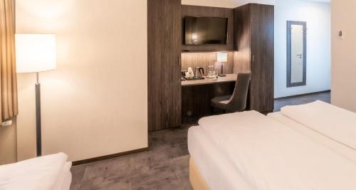 Cama o camas de una habitación en Best Western Plaza Hotel Mannheim