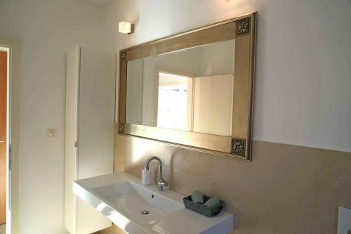 a bathroom with a sink and a mirror at Apartments Apartmani Oh La La - terrace in Supetar