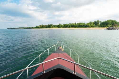 a person on the back of a boat on the water at Queen Ruizi Private Yacht Charter in Pesanggaran