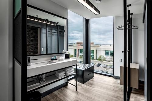 a bathroom with a sink and a large window at Aloft Columbus Easton in Columbus