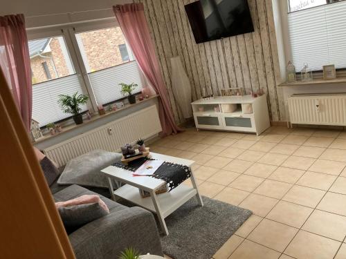 a living room with a couch and a table at Nordseebude in Husum
