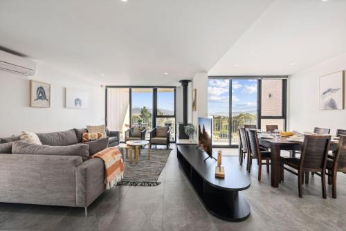 a living room with a couch and a table at Chilam B in Jindabyne