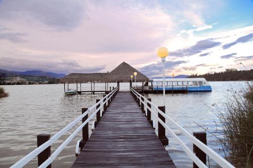 a dock on a body of water with a boat at Estelar Paipa Hotel Spa & Y Centro De Convenciones in Paipa