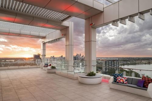 a rendering of the rooftop of a building with a sunset at Aloft Perth in Perth