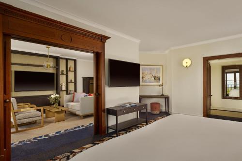 a bedroom with a bed and a living room at Castillo Hotel Son Vida, a Luxury Collection Hotel, Mallorca in Palma de Mallorca
