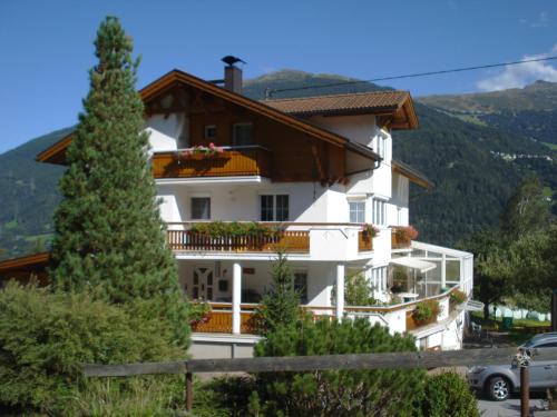 a white house with a christmas tree in front of it at Haus Venetblick in Wenns