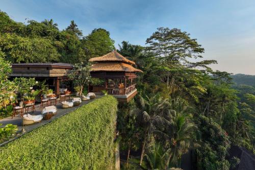 a resort with chairs and a building on a hill at Mandapa, a Ritz-Carlton Reserve in Ubud