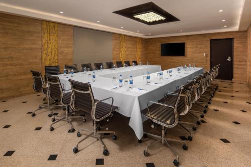 a large conference room with a long table and chairs at Delta Hotels by Marriott Dar es Salaam in Dar es Salaam